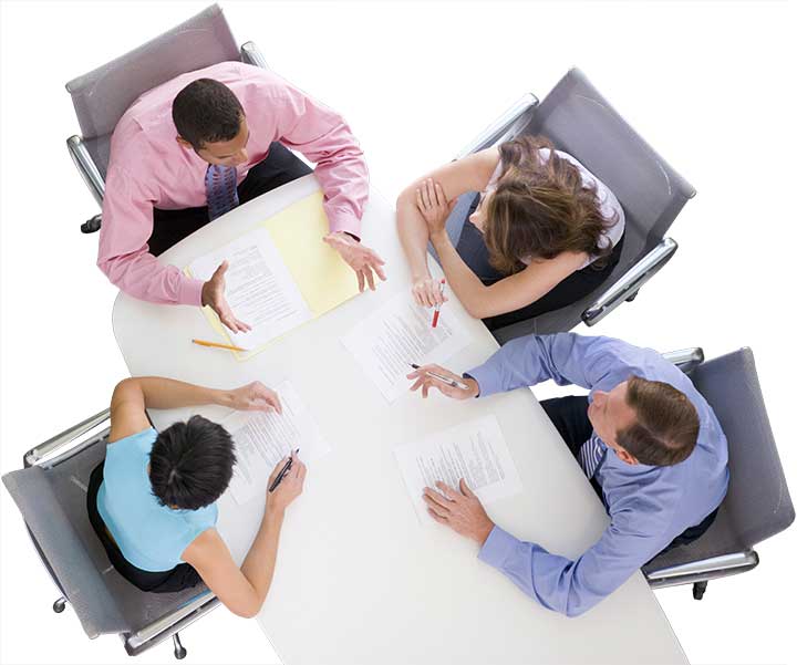 overhead view of 4 coworkers sitting at a table