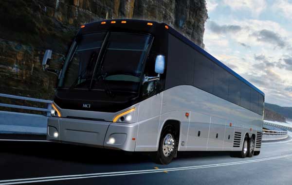 silver motorcoach speeding on highway