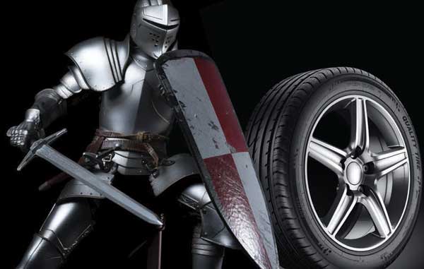 photo of knight in armor with sword nect to a car tire